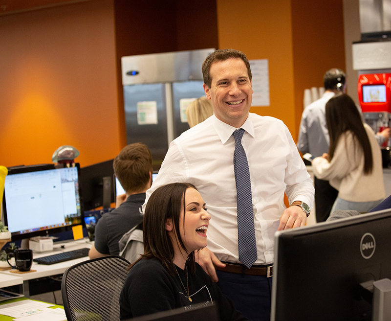 United Wholesale Mortgage CEO mat ishbia laughs with an employee in the office