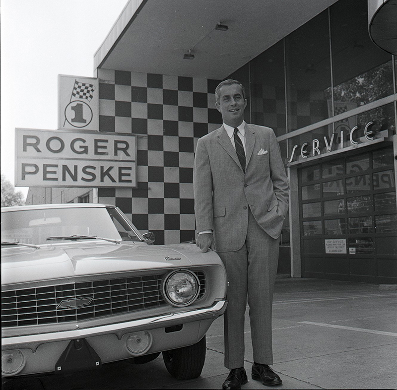 Roger Penske standing outside his first car dealership