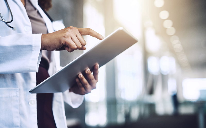 Cropped shot of an unrecognizable doctor using a digital tablet