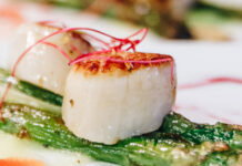 Savor Detroit Dinner Series Announces 2026 Chef Lineup A scallop atop of asparagus.