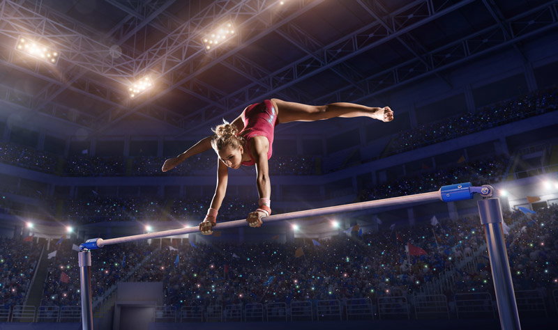A gymnast doing a bar routine.