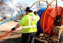 Southfield’s 123NET Awarded $86M in Federal Funding for Michigan Broadband Infrastructure Worker installing high-speed fiber-optic cable