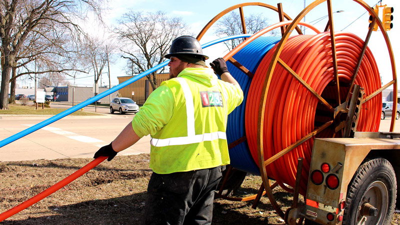 Worker installing high-speed fiber-optic cable