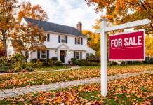 Report: Metro Detroit Home Prices Rebound in September as Regional Sales Decline A two-story home during fall with a "For Sale" sign in the front yard.